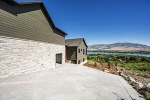 View of patio featuring a water and mountain view