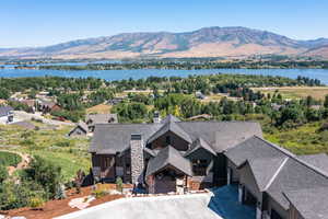 Birds eye view of property with a water and mountain view