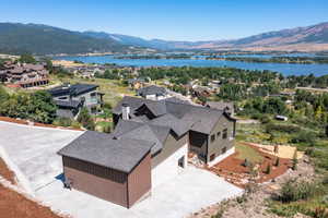 Birds eye view of property with a water and mountain view