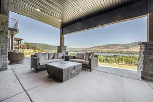 View of patio featuring an outdoor hangout area and a water and mountain view