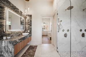 Bathroom featuring vanity and tiled shower