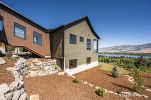 View of side of property featuring a water and mountain view