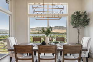 Dining room featuring a mountain view, hardwood / wood-style flooring, and an inviting chandelier