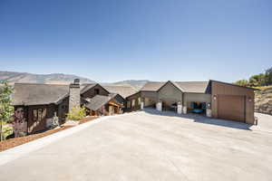 View of front of house featuring a mountain view and a garage