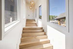 Stairway featuring a chandelier