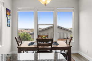 Dining room with hardwood / wood-style flooring and a healthy amount of sunlight