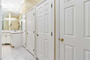 Second primary bathroom with vanity, tile patterned floors, and crown molding