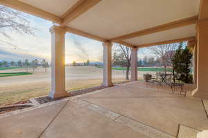 Patio terrace at dusk with a view of golf course