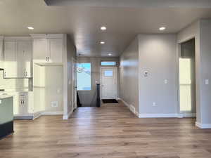 Foyer featuring a notable chandelier and light hardwood / wood-style flooring