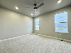 Carpeted empty room with ceiling fan