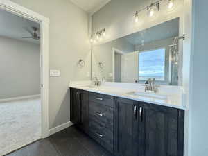 Bathroom with tile patterned floors, ceiling fan, and vanity