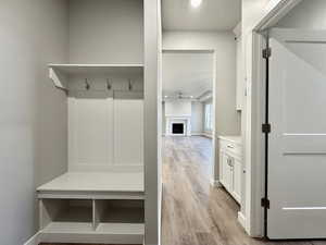 Mudroom with ceiling fan and light hardwood / wood-style flooring