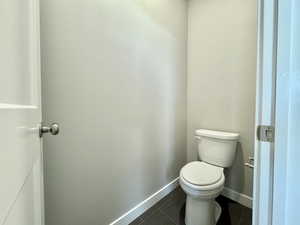 Bathroom with tile patterned flooring and toilet