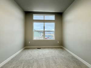 Spare room featuring carpet flooring