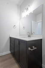 Bathroom with vanity and wood-type flooring