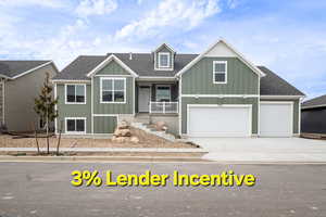 View of front of property featuring a garage and covered porch