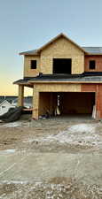 View of garage at dusk