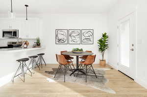 Dining area with light hardwood / wood-style floors