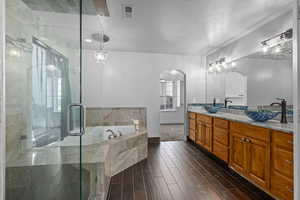 Bathroom featuring separate shower and tub, vanity, a textured ceiling, and hardwood / wood-style flooring