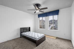 Bedroom with carpet and ceiling fan