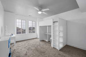 Unfurnished bedroom featuring ceiling fan and carpet floors