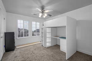 Unfurnished bedroom featuring carpet and ceiling fan