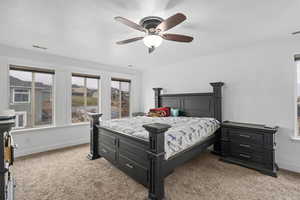 Bedroom featuring carpet flooring, ceiling fan, crown molding, and a textured ceiling