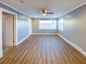 Living room with new windows, new blinds, and new light hardwood-style flooring