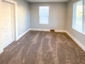 Second  bedroom featuring new door, new windows, and new blinds