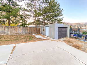 Detached garage with a mountain view and fenced yard