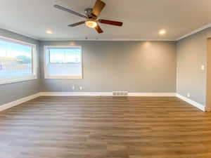 Spacious living room with fresh paint, new flooring, new windows, new blinds, and new ceiling fan