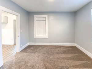 Main bedroom with new carpet, fresh paint, and new light fixture