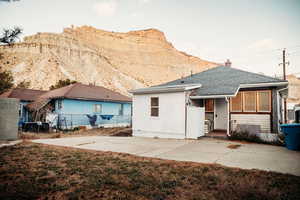 Back of the property with a mountain view and patio