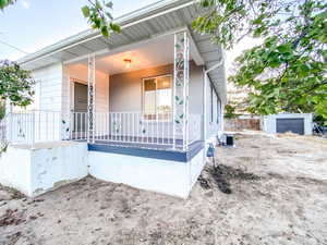 Front view of the home showcasing the new deck, new central AC unit, and spacious side yard