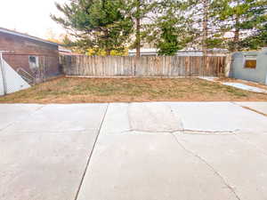 Backyard with a patio and wooden fencing