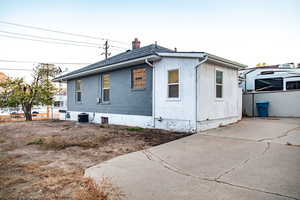 Side view of the property with new central AC unit and patio area