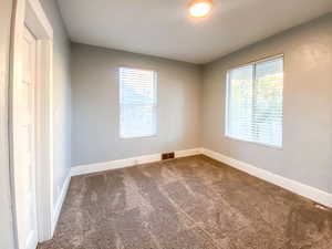 Second bedroom has new door, new paint, new carpet, new windows, new blinds, and a healthy amount of sunlight