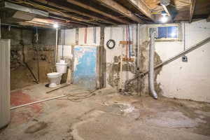 Basement featuring a secondary toilet and washer/dryer hookups