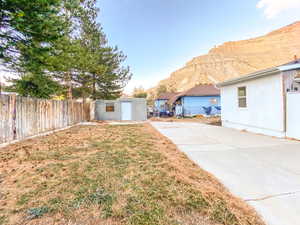 Yard with a mountain view and detached garage