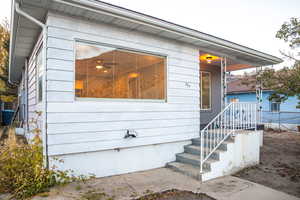 Front view highlighting the living  room window, with the home’s welcoming entrance