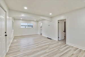 Unfurnished room with light hardwood / wood-style floors