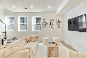 Living room with light hardwood / wood-style floors