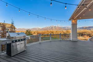 Wooden terrace with a mountain view and area for grilling