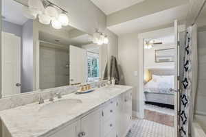 Bathroom featuring a shower with shower curtain, ceiling fan, wood-type flooring, and vanity