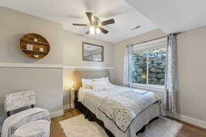 Bedroom featuring hardwood / wood-style flooring and ceiling fan