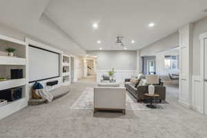 Living room with built in shelves and light colored carpet