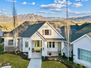 View of front of property with a mountain view and a front yard