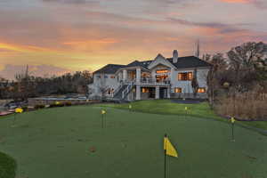 View of front of house with a yard and a balcony