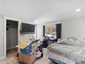 Bedroom with a closet and light hardwood / wood-style flooring