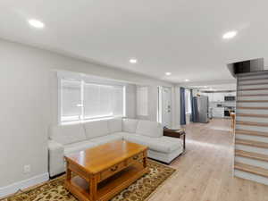 Living room with light hardwood / wood-style floors